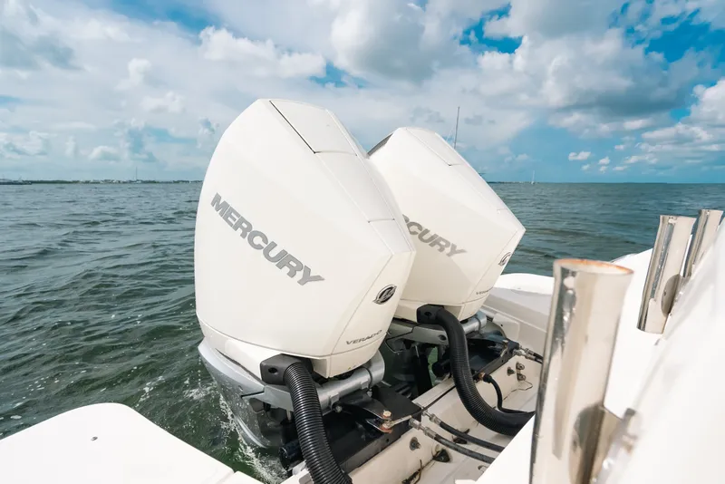 Slide: The Image of 2024 Boston Whaler 320 Vantage with twin Mercury outboard engines on open water. - 41