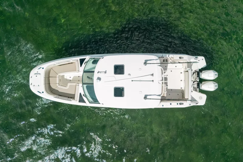 Slide: The Image of Aerial view of 2024 Boston Whaler 320 Vantage boat on clear green water. - 18