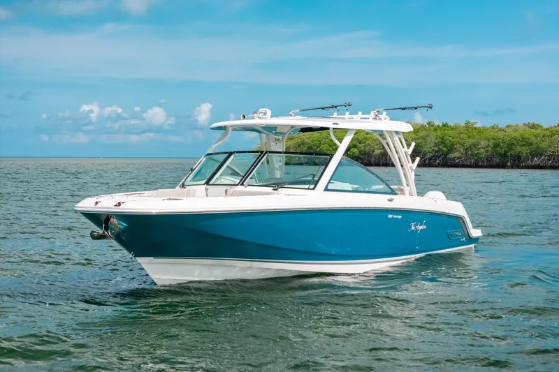Slide: The Image of 2024 Boston Whaler 320 Vantage boat cruising on a sunny day, blue water and sky backdrop. - 2