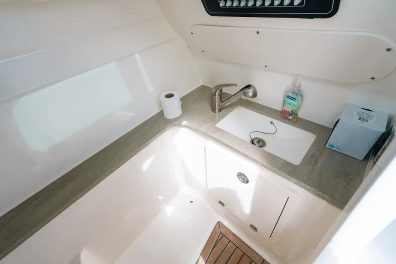 Slide: The Image of 2024 Boston Whaler 320 Vantage boat interior with sink and countertop amenities. - 44