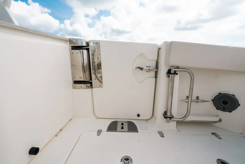 Slide: The Image of 2024 Boston Whaler 320 Vantage boat interior, featuring stainless steel hardware and white finish. - 28