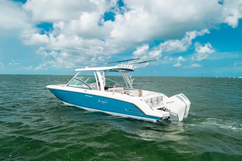 Slide: The Image of 2024 Boston Whaler 320 Vantage boat cruising on open water under a clear sky. - 14