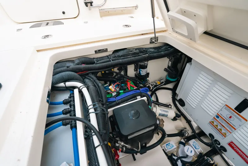 Slide: The Image of 2024 Boston Whaler 320 Vantage engine compartment with wiring and components. - 53