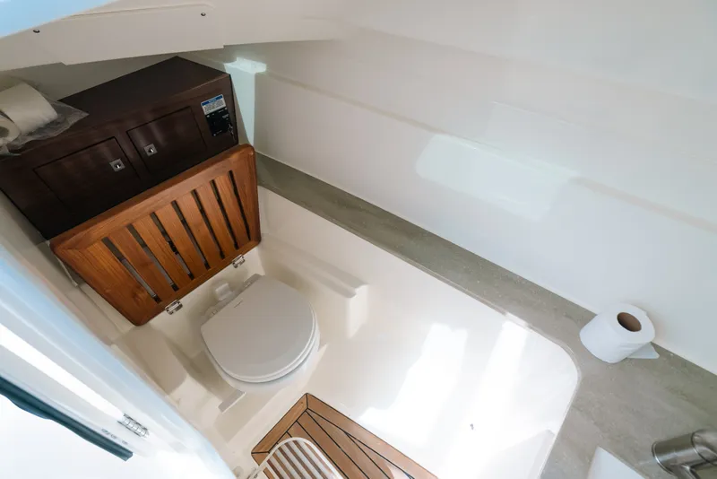 Slide: The Image of 2024 Boston Whaler 320 Vantage boat bathroom with wooden accents and modern fixtures. - 47