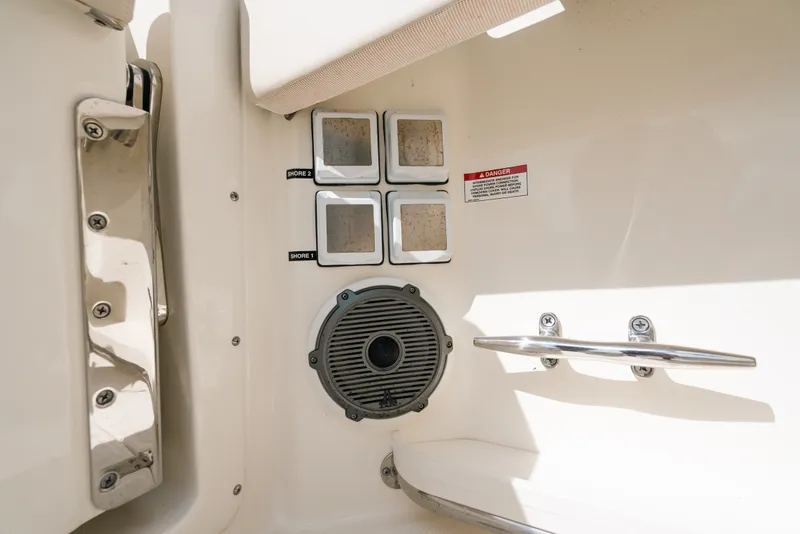 Slide: The Image of 2024 Boston Whaler 320 Vantage boat interior with speaker and shore power outlets. - 43