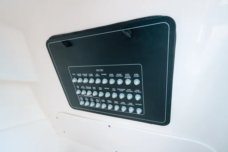 Slide: The Image of Control panel of 2024 Boston Whaler 320 Vantage boat, featuring various switches and labels. - 23