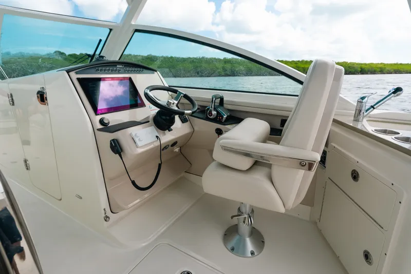 Slide: The Image of 2024 Boston Whaler 320 Vantage helm with modern controls and comfortable seating. - 34