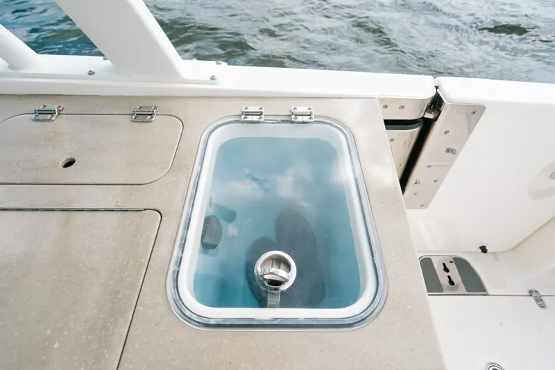 Slide: The Image of 2024 Boston Whaler 320 Vantage boat deck with built-in storage compartment. - 33