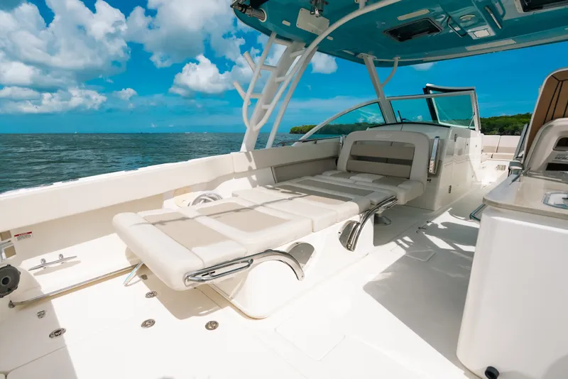 Slide: The Image of 2024 Boston Whaler 320 Vantage boat interior with seating, ocean view, and blue sky. - 49