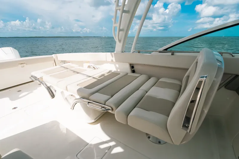 Slide: The Image of 2024 Boston Whaler 320 Vantage boat interior with luxurious seating and ocean view. - 50