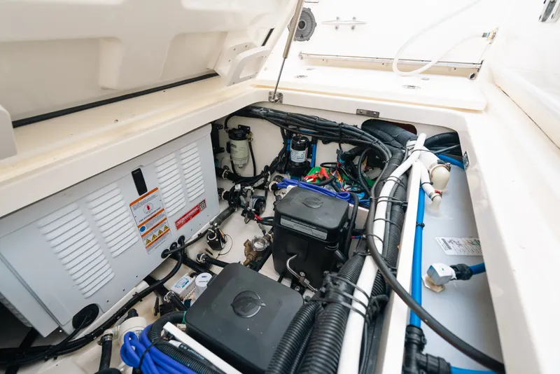 Slide: The Image of Engine compartment of 2024 Boston Whaler 320 Vantage, showcasing wiring and components. - 54