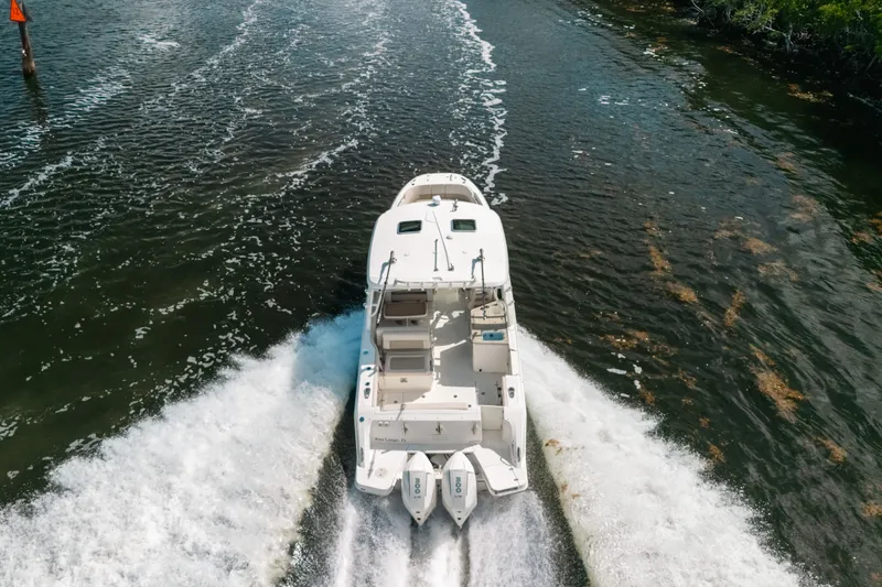 Slide: The Image of 2024 Boston Whaler 320 Vantage cruising on a river, aerial view. - 4