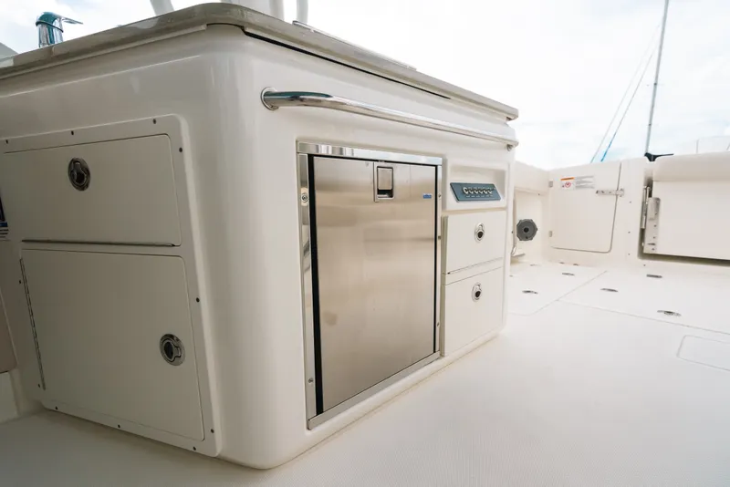Slide: The Image of 2024 Boston Whaler 320 Vantage boat interior with stainless steel storage and control panel. - 55