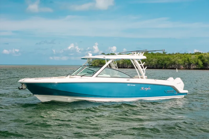 The Image of 2024 Boston Whaler 320 Vantage boat on water, featuring sleek blue and white design. - 1