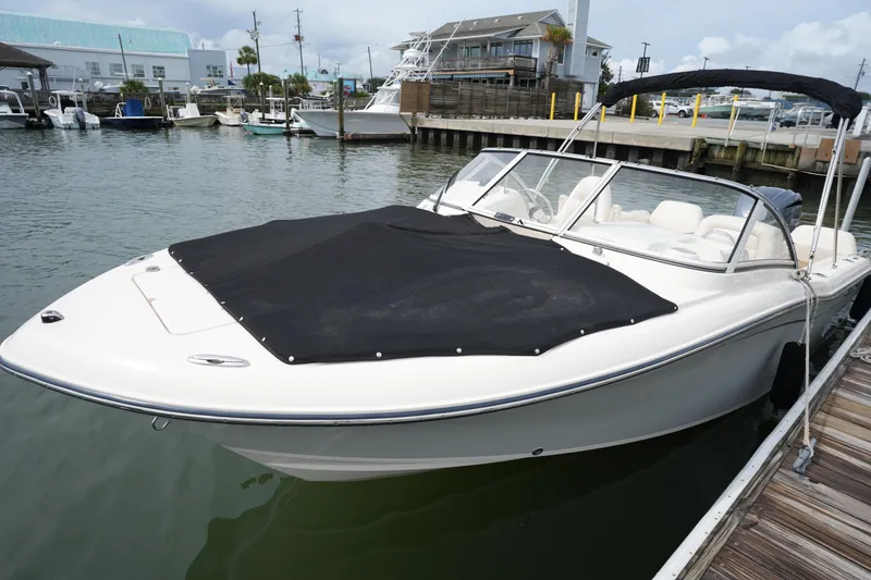 Slide: The Image of 2022 Grady-White Freedom 215 boat docked at marina, covered and ready for use. - 30