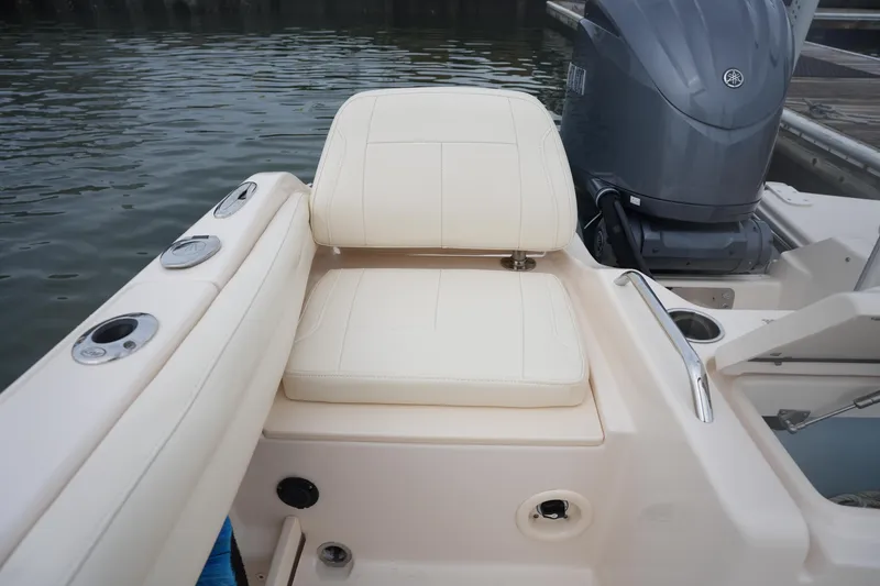 Slide: The Image of 2022 Grady-White Freedom 215 boat seat and engine detail by the water. - 14