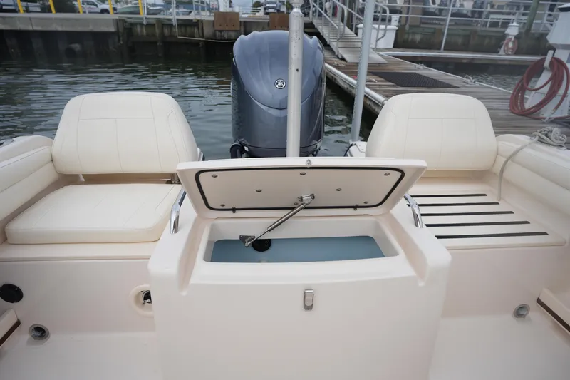 Slide: The Image of 2022 Grady-White Freedom 215 boat interior with open storage compartment at dock. - 15
