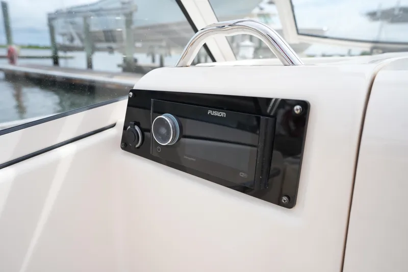 Slide: The Image of Fusion stereo system on 2022 Grady-White Freedom 215 boat dashboard. - 25