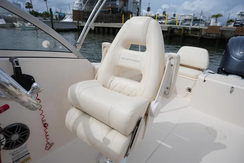 Slide: The Image of 2022 Grady-White Freedom 215 boat interior with luxurious seating at marina. - 18