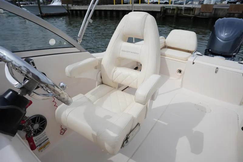 Slide: The Image of 2022 Grady-White Freedom 215 boat interior with luxurious seating and steering wheel. - 19
