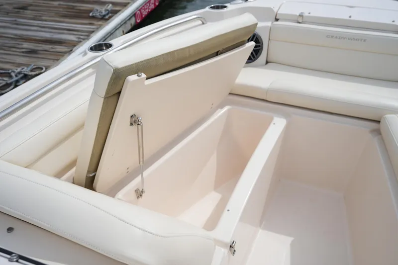 Slide: The Image of 2022 Grady-White Freedom 215 boat with open storage compartment and cushioned seating. - 28