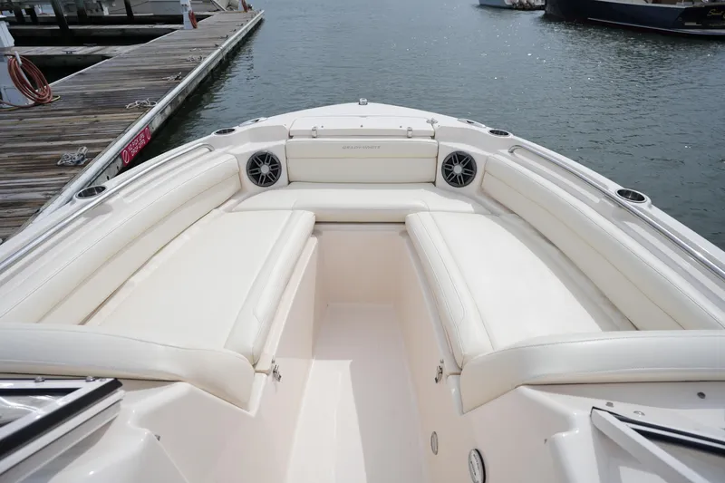 Slide: The Image of 2022 Grady-White Freedom 215 boat interior with white seating at dock. - 27