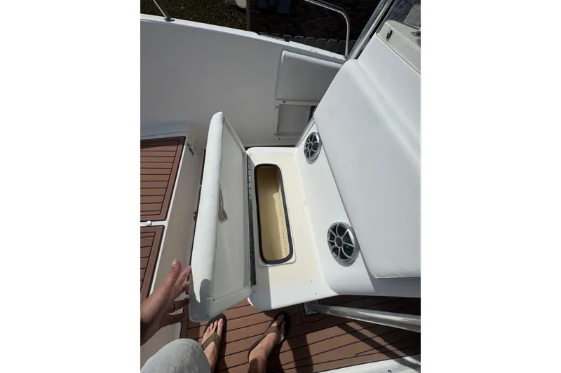 Slide: The Image of 1993 Hydra-Sports 2300 CC boat interior with open storage compartment and speakers. - 5