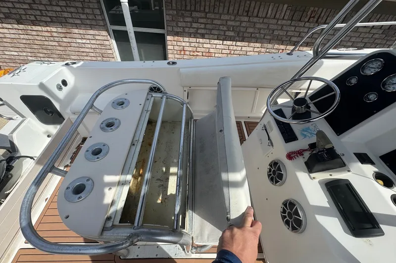 Slide: The Image of 1993 Hydra-Sports 2300 CC boat interior with steering wheel and fishing rod holders. - 8