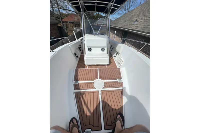 Slide: The Image of 1993 Hydra-Sports 2300 CC boat interior with teak flooring and seating area. - 3