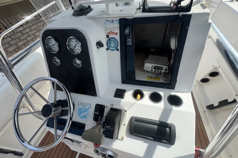 Slide: The Image of 1993 Hydra-Sports 2300 CC boat dashboard with steering wheel and gauges. - 9