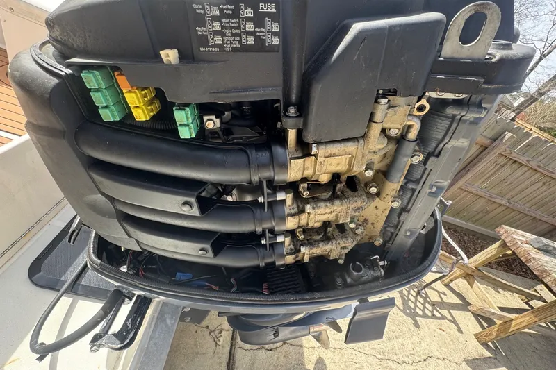 Slide: The Image of 1993 Hydra-Sports 2300 CC outboard motor with visible engine components and wiring. - 11