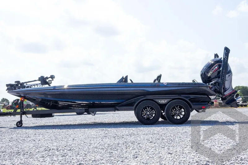 Slide: The Image of 2027 Skeeter FXE21 Apex boat on trailer, parked on gravel under a cloudy sky. - 9