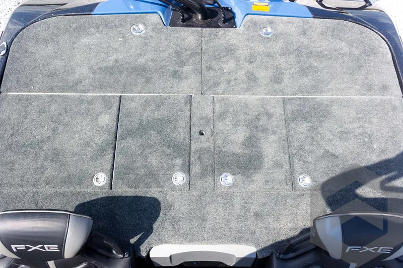 Slide: The Image of 2027 Skeeter FXE21 Apex boat deck with gray carpeting and FXE branding. - 21