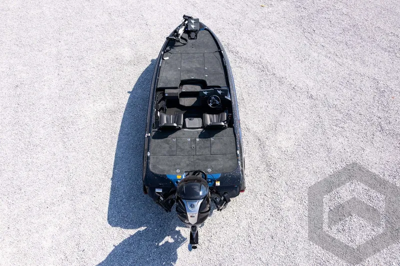 Slide: The Image of 2027 Skeeter FXE21 Apex boat, aerial view on gravel surface. - 33