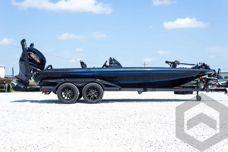 Slide: The Image of 2027 Skeeter FXE21 Apex boat on trailer, side view, parked on gravel. - 5