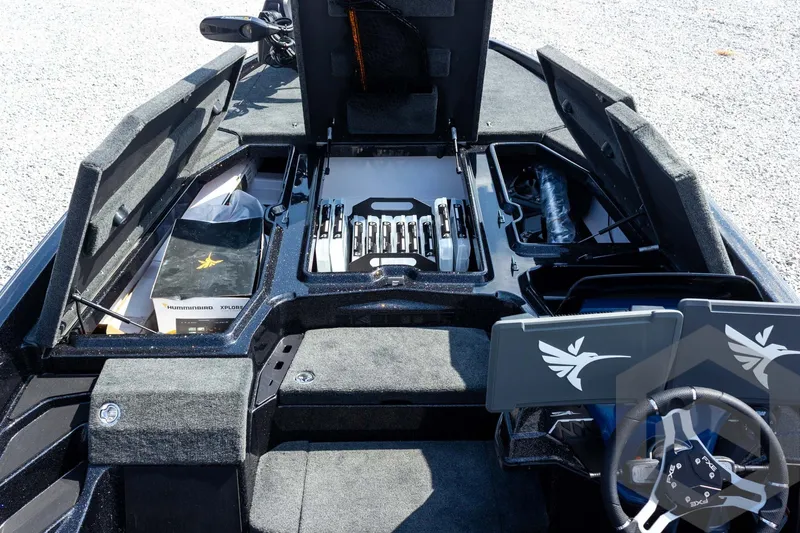 Slide: The Image of 2027 Skeeter FXE21 Apex boat interior with storage compartments and steering wheel. - 15