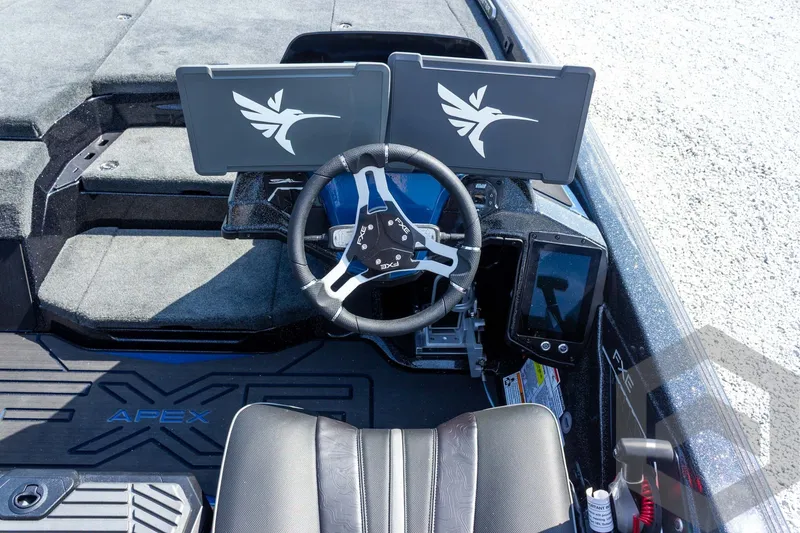 Slide: The Image of 2027 Skeeter FXE21 Apex boat cockpit with dual screens and steering wheel. - 20
