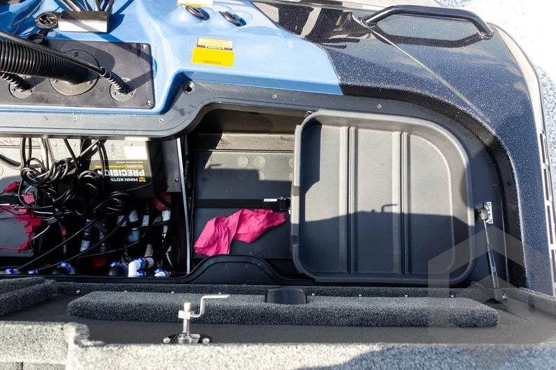 Slide: The Image of Interior view of a 2027 Skeeter FXE21 Apex boat, showcasing storage compartments and wiring. - 25