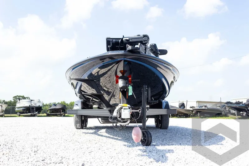 Slide: The Image of 2027 Skeeter FXE21 Apex boat on trailer, displayed outdoors on gravel. - 3