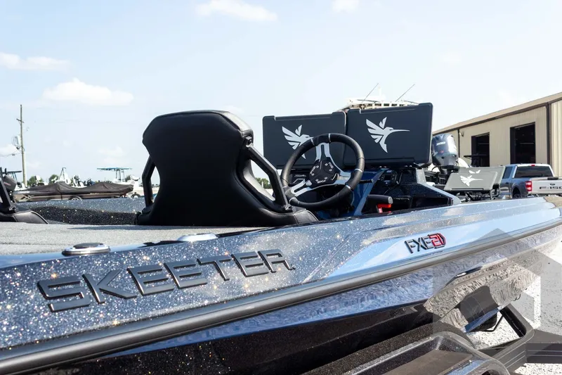 Slide: The Image of 2027 Skeeter FXE21 Apex boat with sleek design and modern steering console. - 13