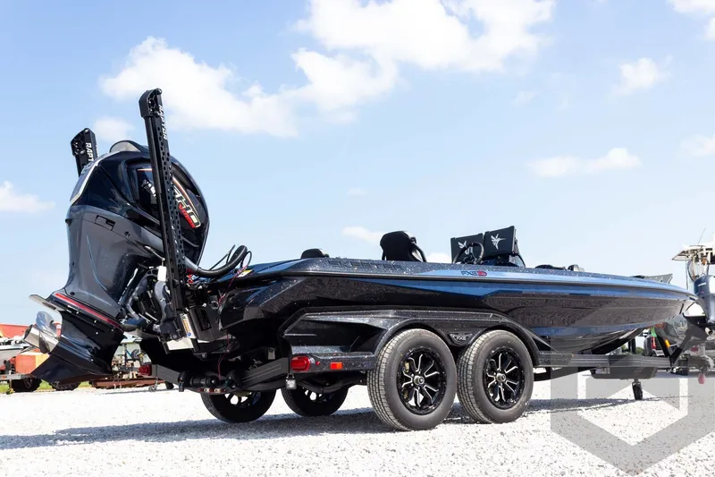 Slide: The Image of 2027 Skeeter FXE21 Apex boat on trailer under clear sky. - 6
