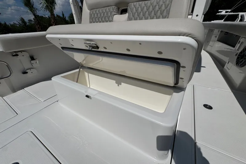 Slide: The Image of Open storage compartment on 2027 Solace 32CS boat, featuring cushioned seating. - 46
