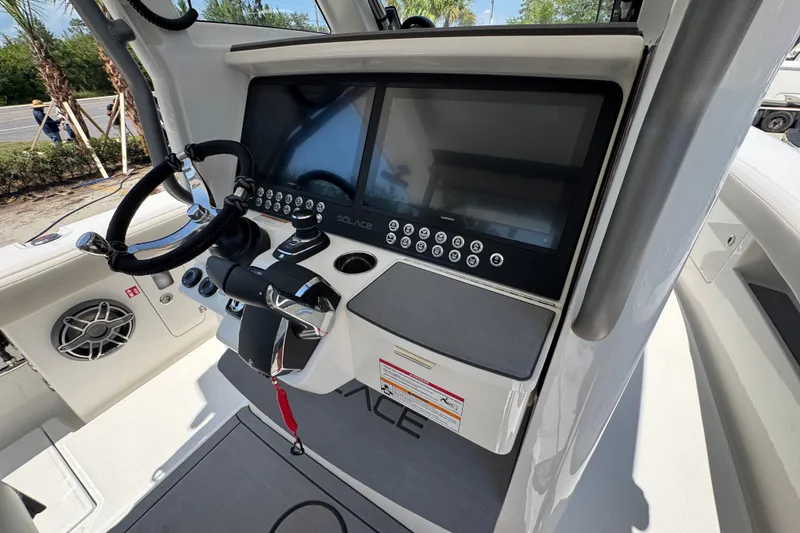 Slide: The Image of Helm of 2027 Solace 32CS boat with advanced navigation controls and dual screens. - 41