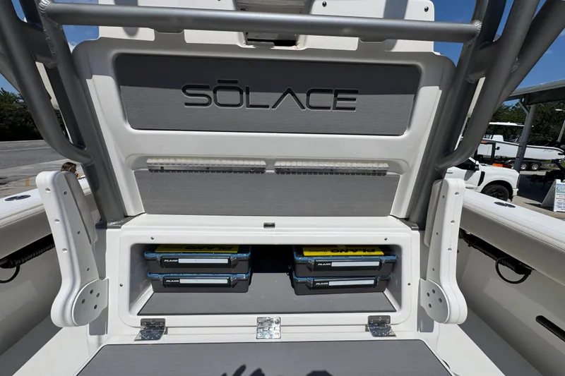 Slide: The Image of Storage compartment of a 2027 Solace 32CS boat with organized tackle boxes. - 45