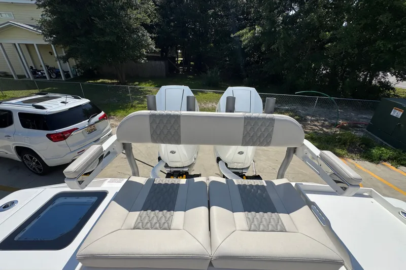 Slide: The Image of 2027 Solace 32CS boat with dual engines, parked near a white SUV. - 52