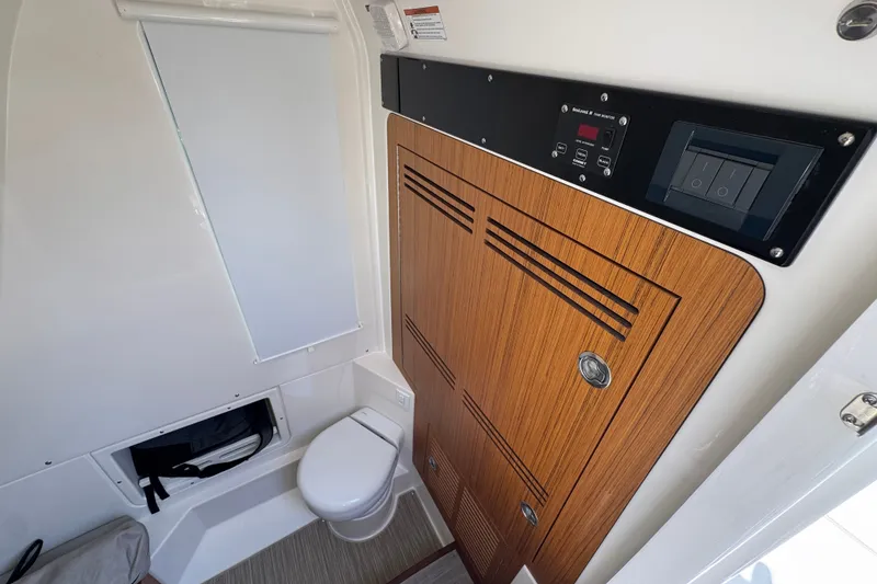 Slide: The Image of 2027 Solace 32CS boat interior with modern bathroom and wooden cabinetry. - 28
