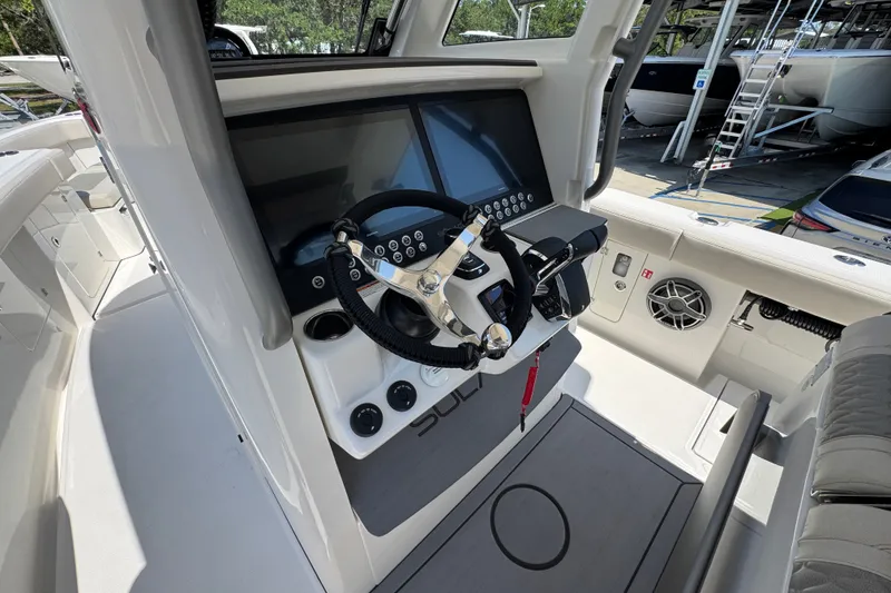 Slide: The Image of Helm of 2027 Solace 32CS boat with modern controls and steering wheel. - 38