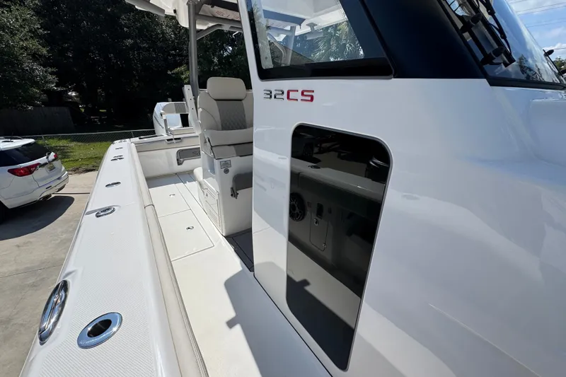 Slide: The Image of 2027 Solace 32CS boat with sleek design and modern features, docked outdoors. - 27