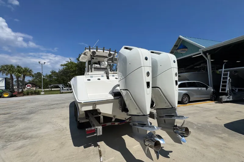 Slide: The Image of 2027 Solace 32CS boat with dual outboard engines in a sunny marina setting. - 16