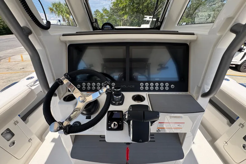 Slide: The Image of Helm of 2027 Solace 32CS boat with dual screens and steering wheel. - 39